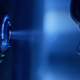 Kinsey Locke looking through a keyhole.